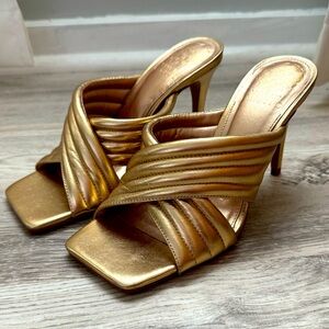 Gold metallic leather heels with a square toe and heel, with criss cross design
